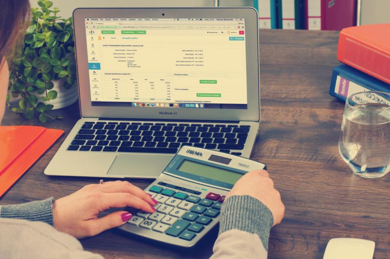 A laptop and calculator on an accountant’s desk
