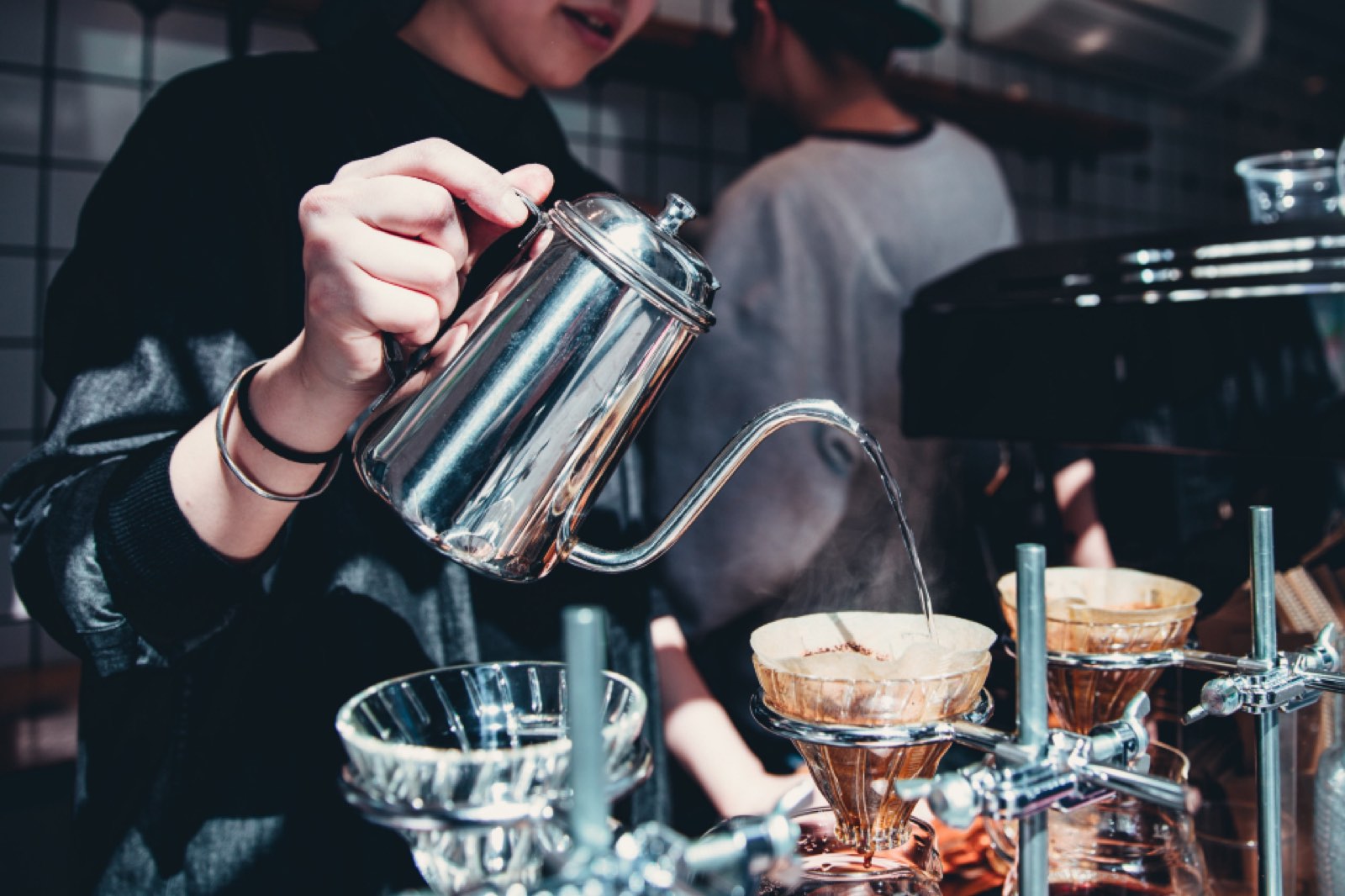 A barista making pour-over coffee