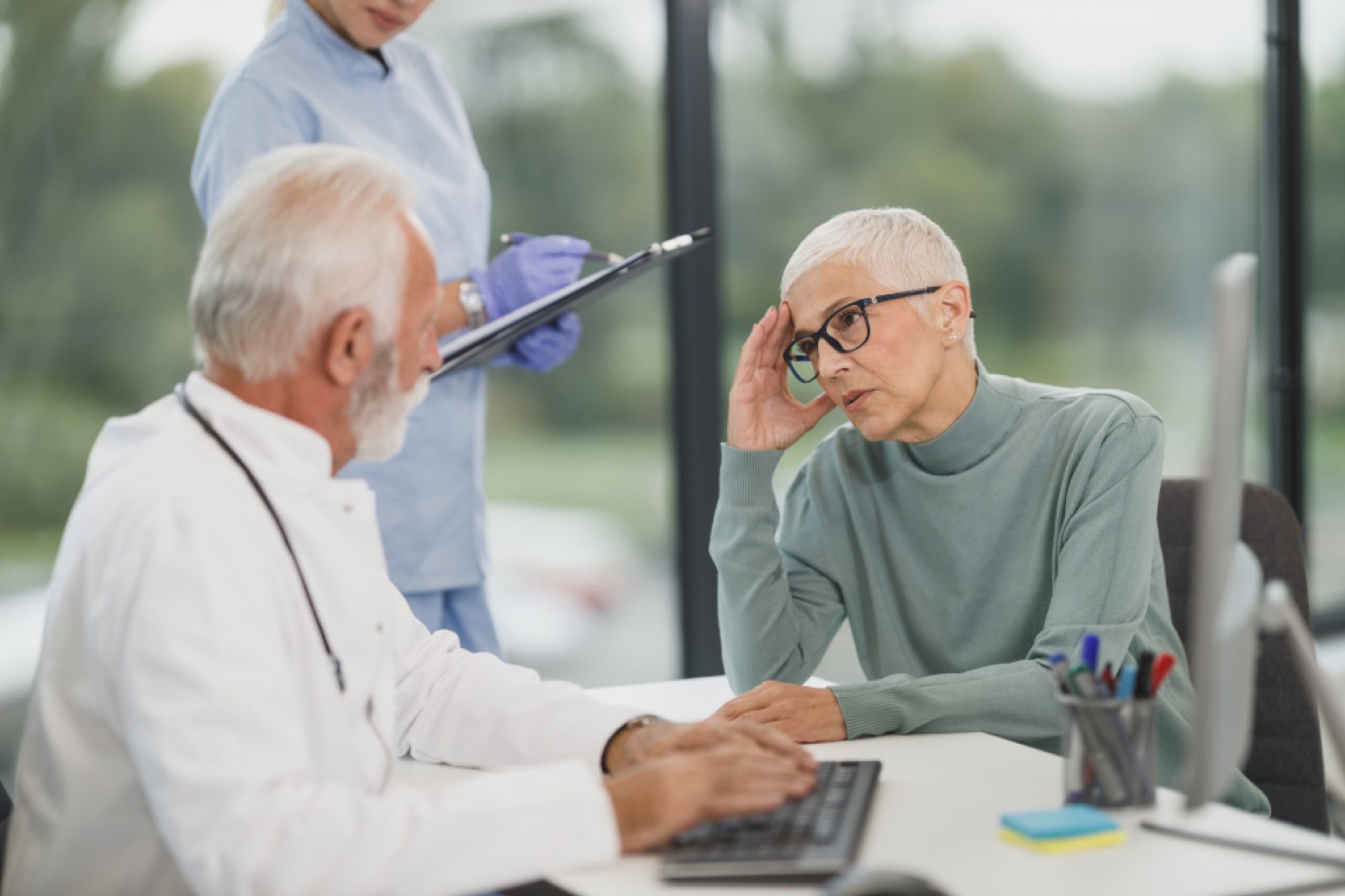 A doctor talking with an older patient in a clinic