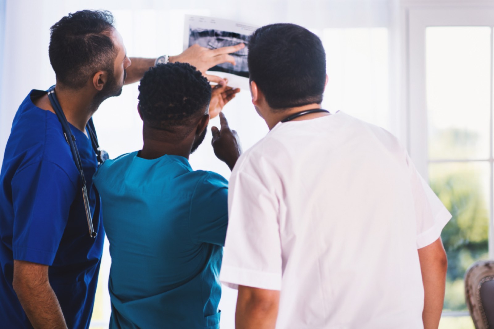A medical team looking at a scan together