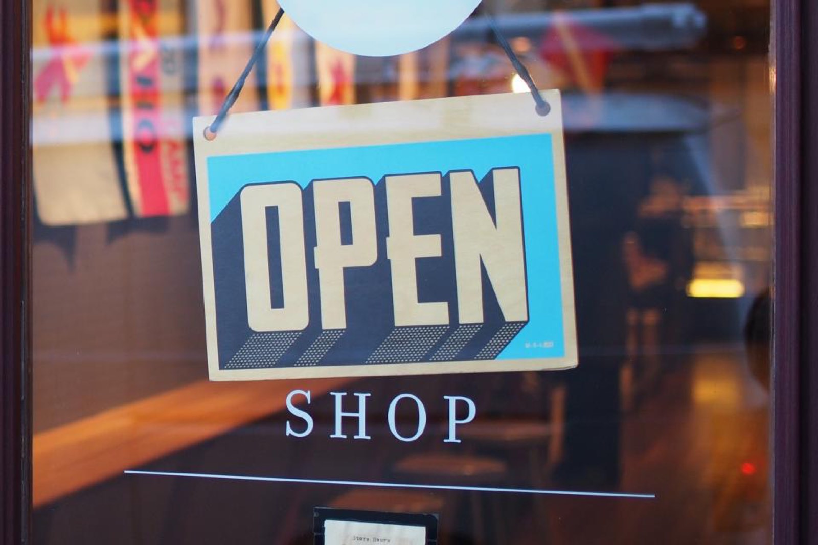 An Open sign hanging in a shop door