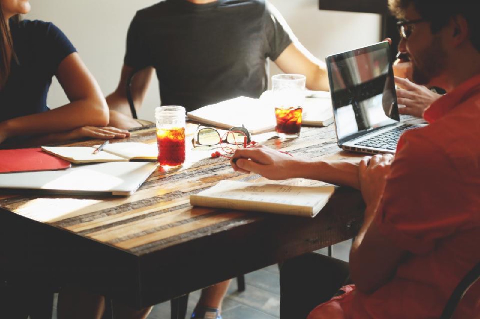 A team working together around a table with laptops