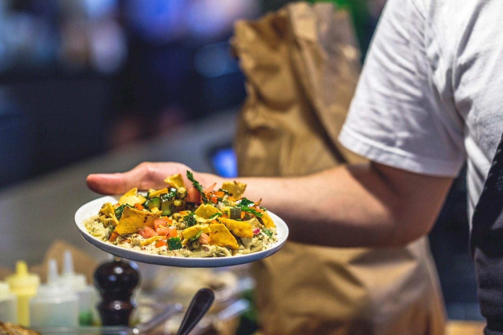 A waiter carrying a plate of food